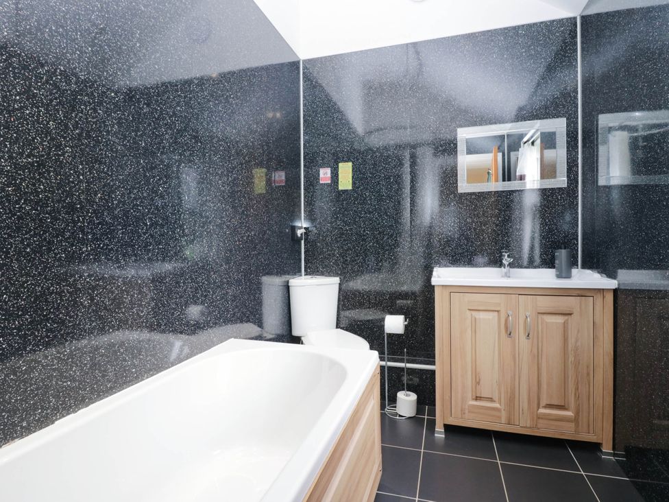 A bathroom with a bathtub, toilet, and sink at Bramble near Cleator Moor