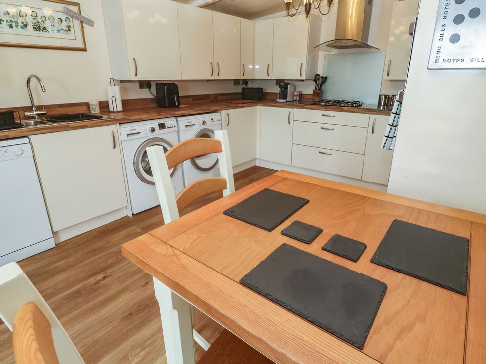 A kitchen with table and appliances at The Hideaway at Monterey Helston