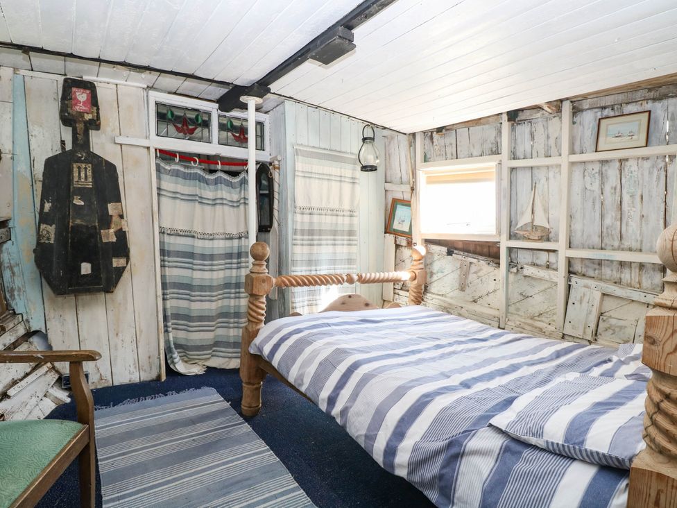 A bedroom with a bed and wall artwork at Ladies of Bolton in Horsford