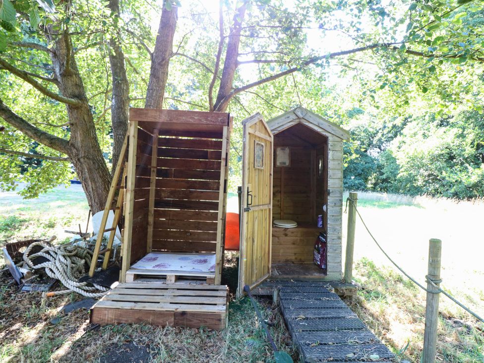 A wooden toilet structure with a path at Ladies of Bolton in Horsford