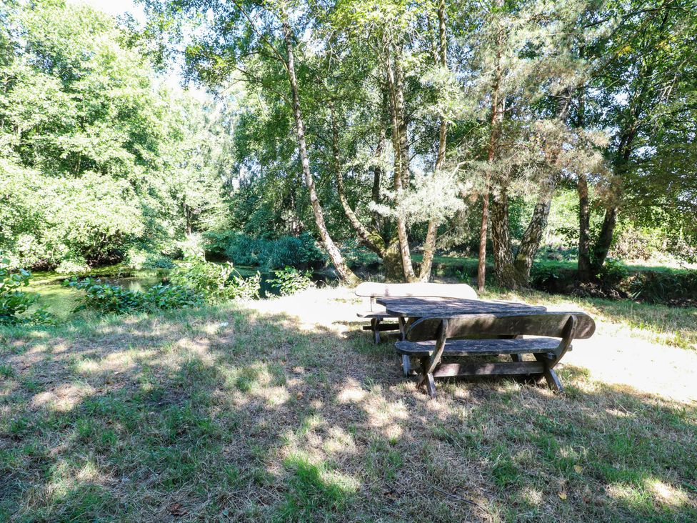 A table and benches near water at Ladies of Bolton in Horsford
