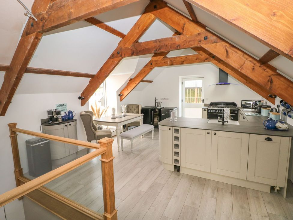 A kitchen with a table and chairs at The Cartbarn at Cadwgan Farm near Whitland