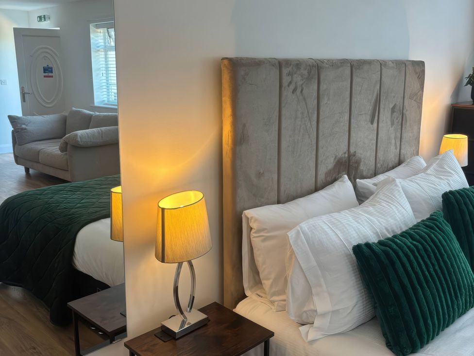 A bedroom with a bed and a couch at Truly Scrumptious in Yarm