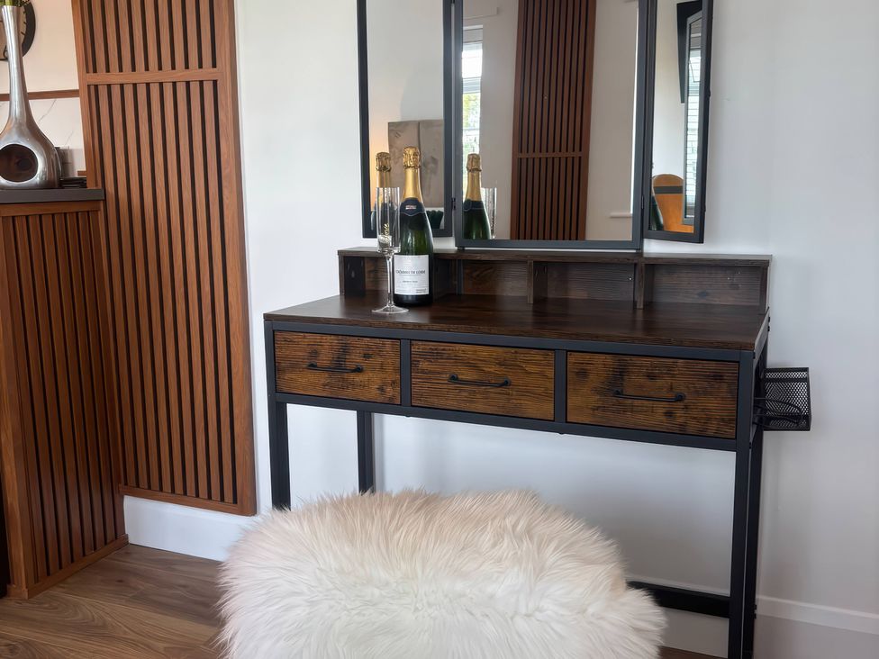 A vanity with champagne and a mirror at Truly Scrumptious in Yarm