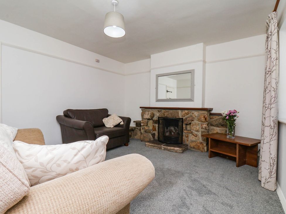 A living room with a fireplace and a sofa at Farmhouse in Whitby