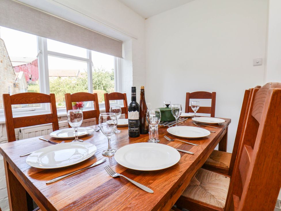 A dining room with a table set for dinner at the Farmhouse in Whitby