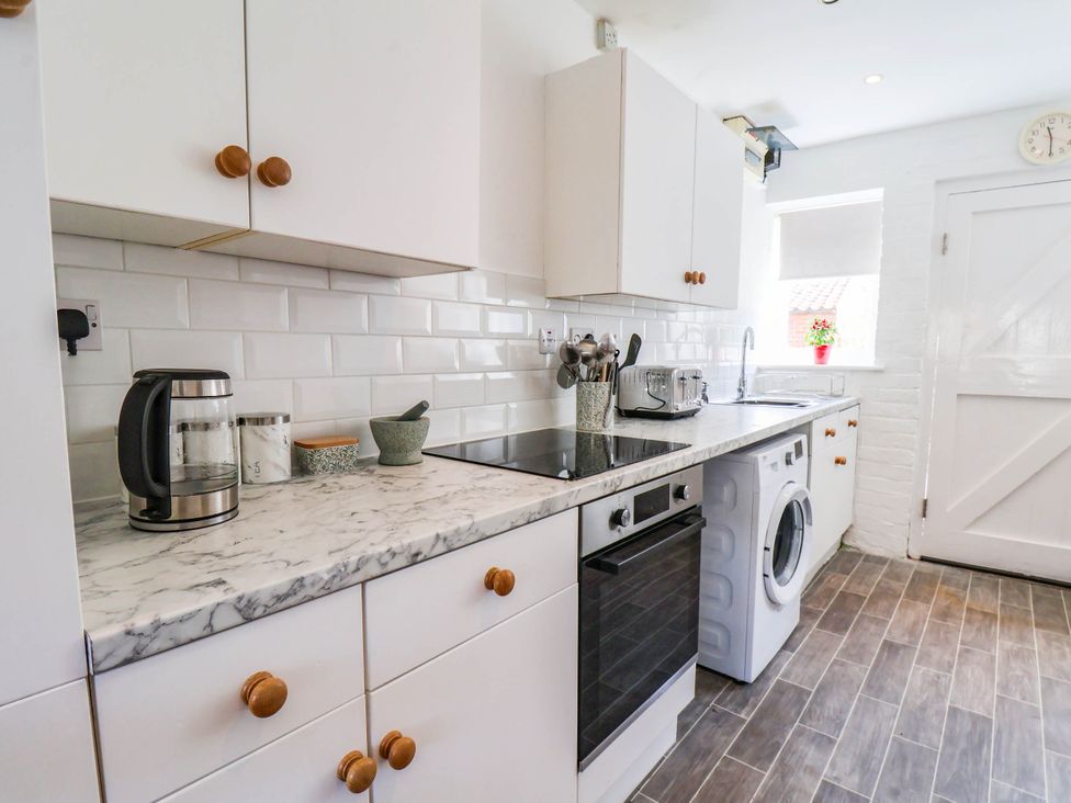 A kitchen with appliances and utensils at the Farmhouse in Whitby