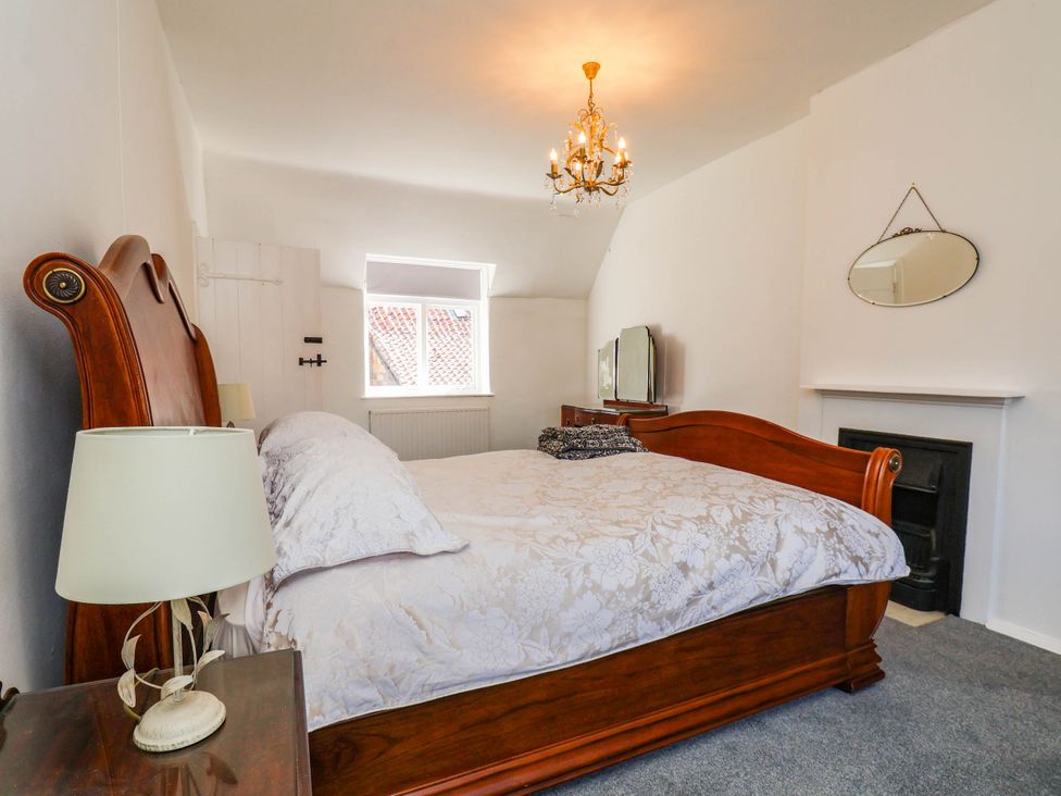 A bedroom with a bed and TV at the Farmhouse in Whitby