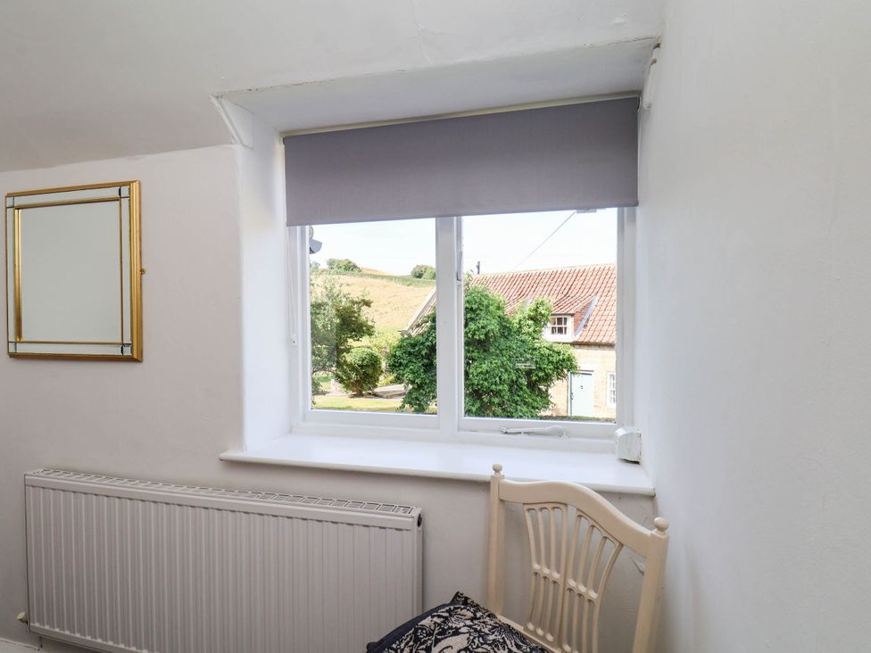 A room with a window and chair at Farmhouse in Whitby