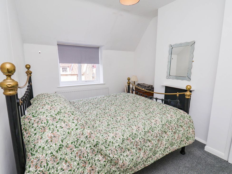 A bedroom with a bed and a window at the Farmhouse in Whitby