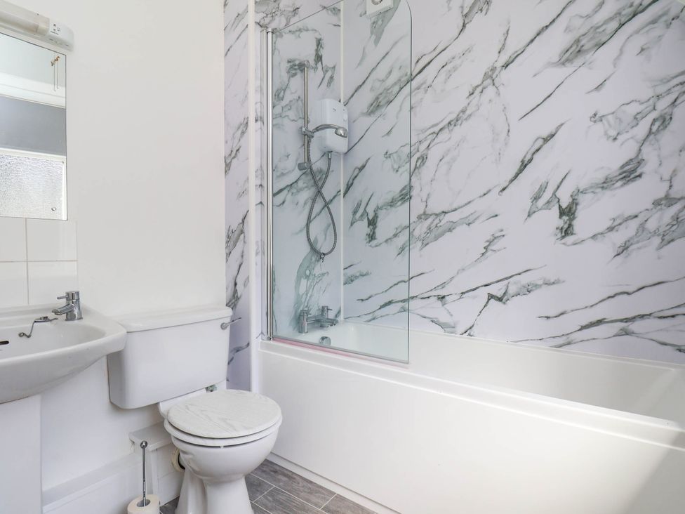 A bathroom with a bathtub and shower at Farmhouse in Whitby