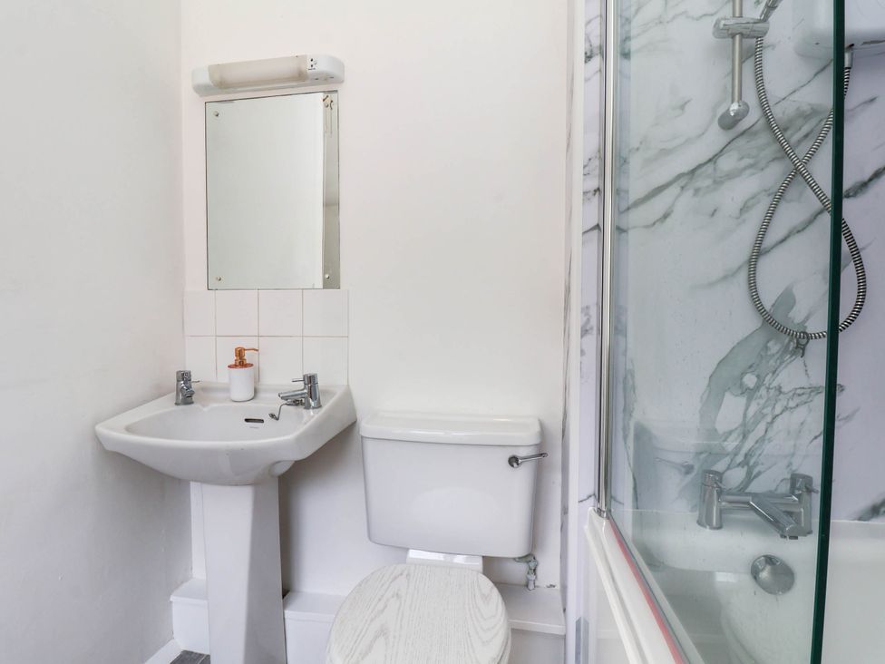 A bathroom with a sink, toilet, and shower at Farmhouse in Whitby