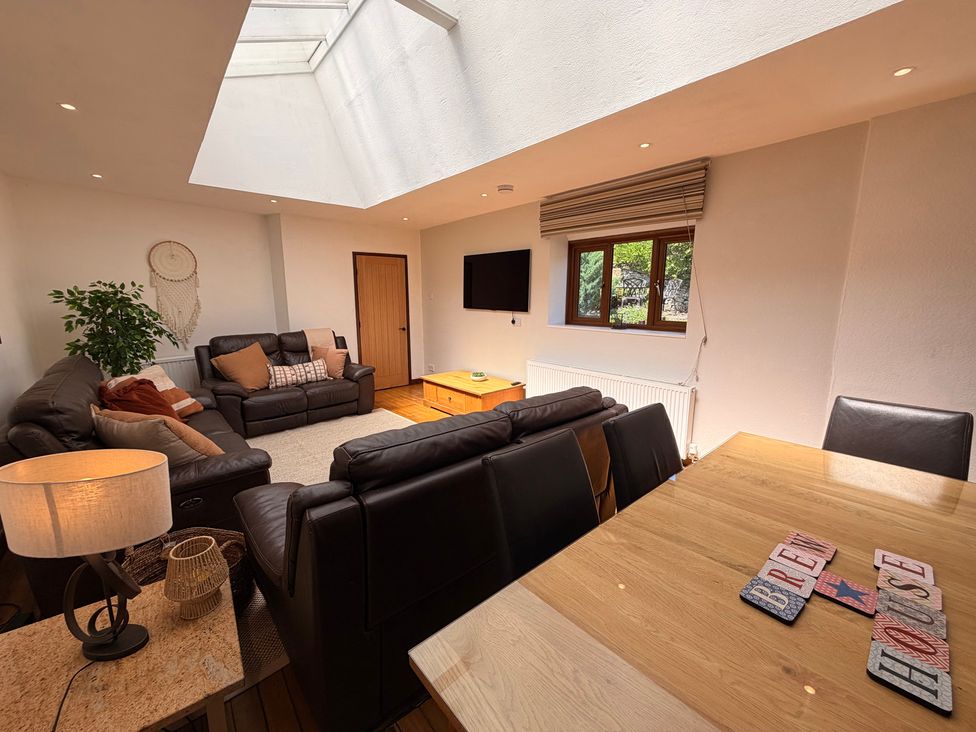 A living room with a television and seating area at The Brew House in Bakewell