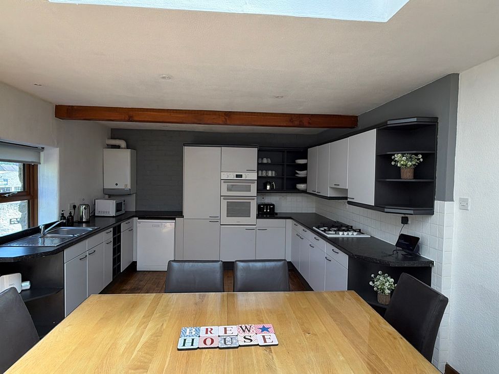 A kitchen with a table and chairs at The Brew House in Bakewell