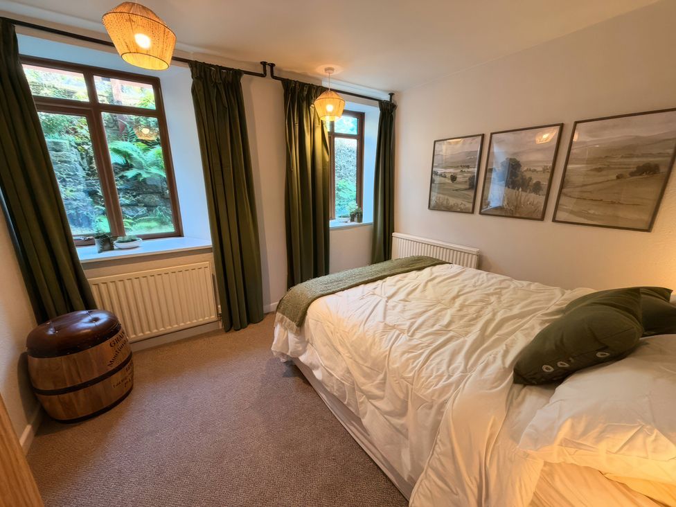 A bedroom with a bed and window at The Brew House in Bakewell