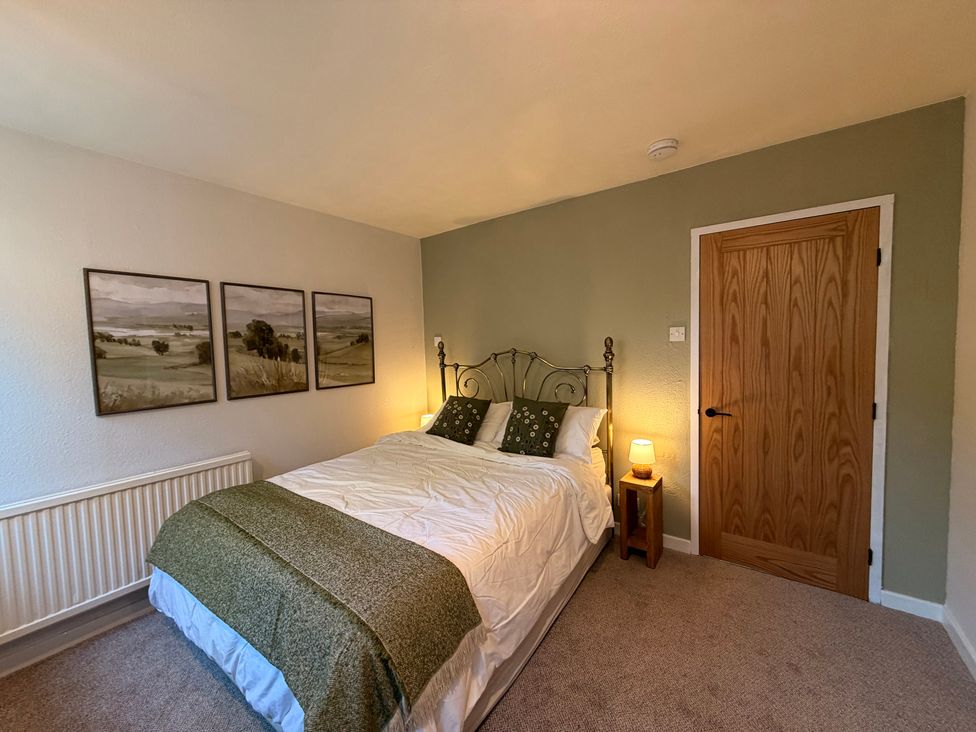 A bedroom with a bed and wall art at The Brew House in Bakewell