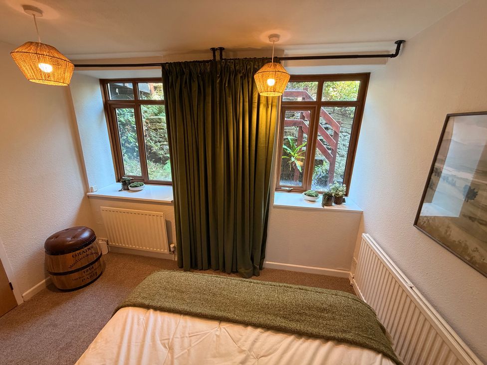 A bedroom with a bed and window at The Brew House in Bakewell