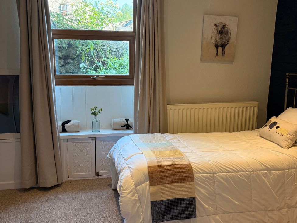 A bedroom with a bed and window at The Brew House in Bakewell