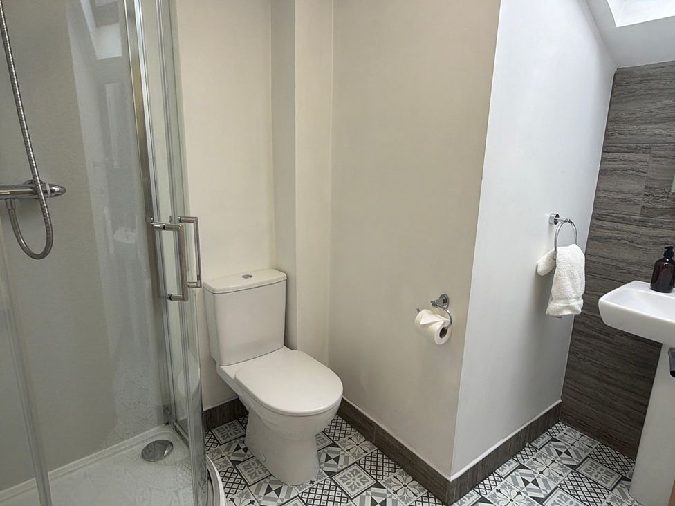 A bathroom with a sink, toilet and shower at The Brew House in Bakewell