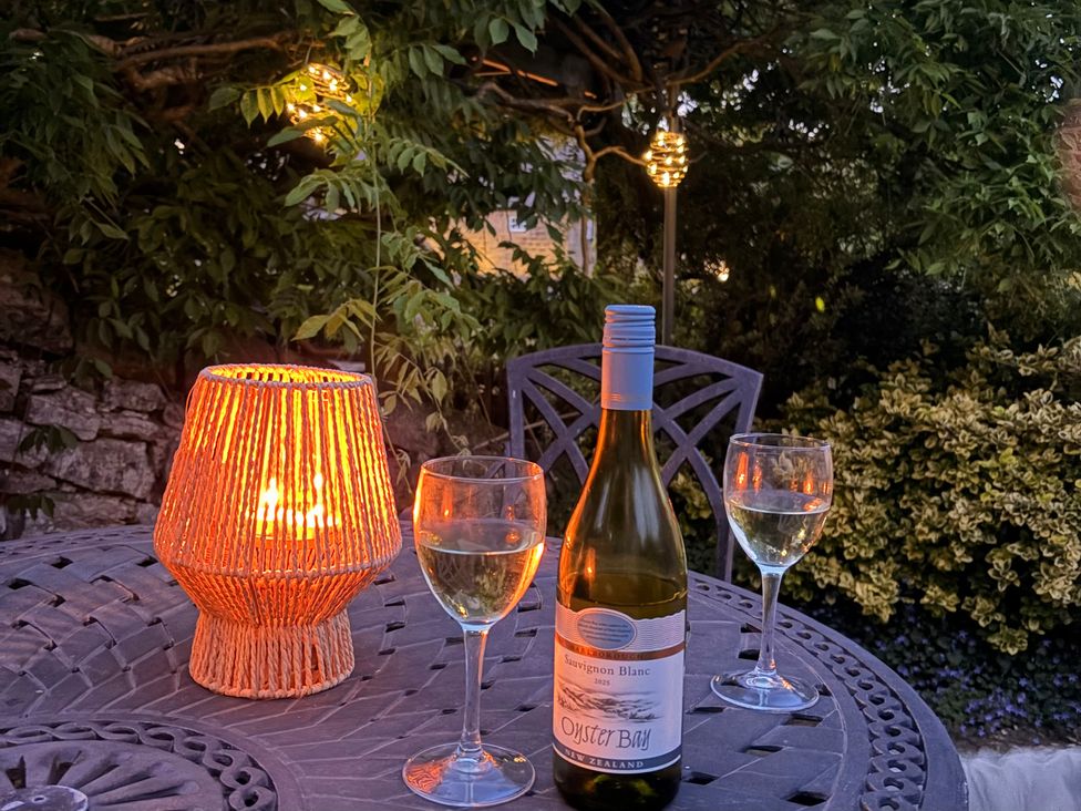 A table with wine glasses and a lamp in an outdoor setting at The Brew House in Bakewell