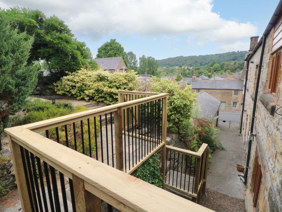 A garden with a staircase and wooden railing at The Brew House in Bakewell