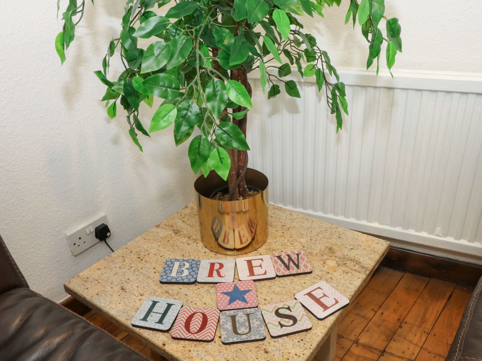 A living room with a plant and letters spelling Brew House at The Brew House in Bakewell