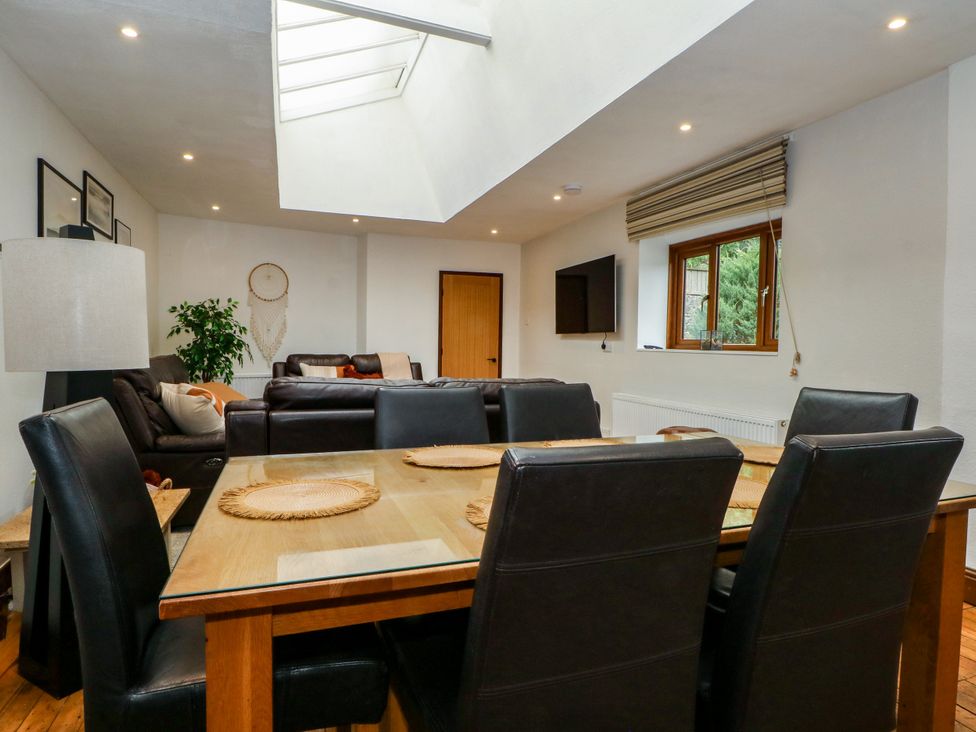 A dining room with table and chairs and a skylight at The Brew House in Bakewell