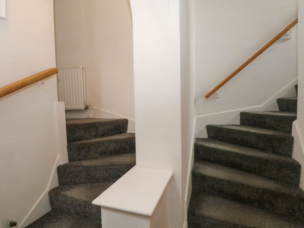 A staircase with a handrail and a radiator at The Brew House in Bakewell