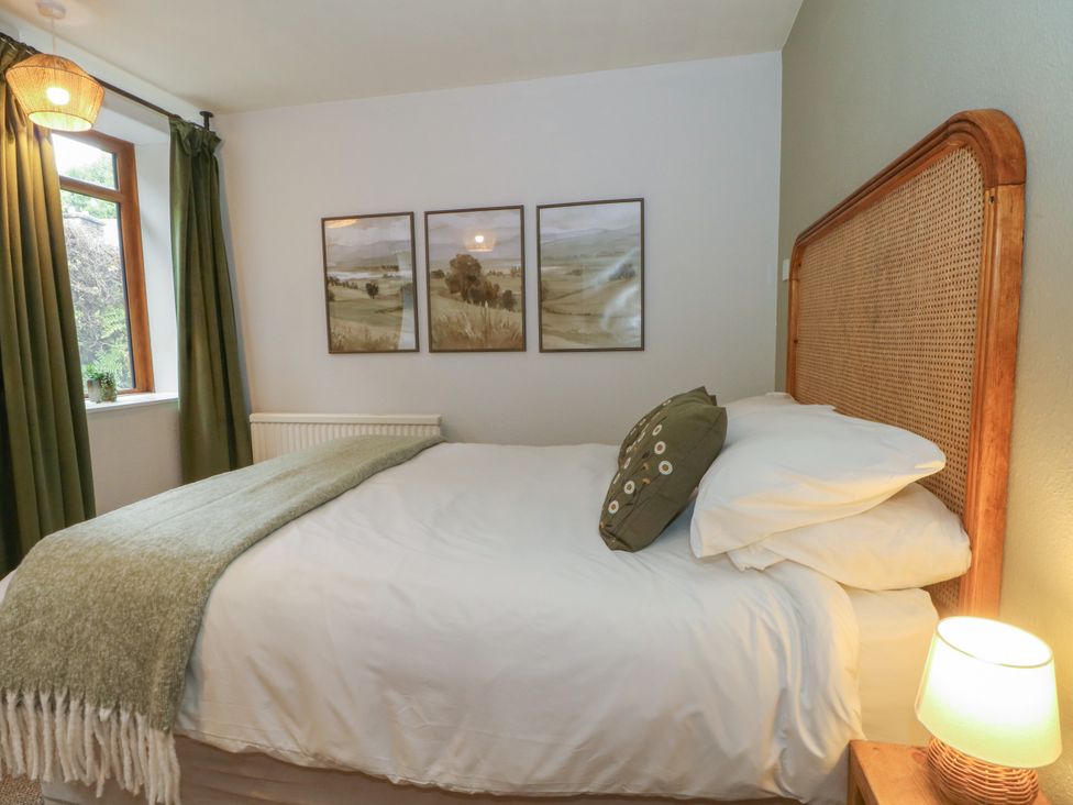A bedroom with a bed and pictures on the wall at The Brew House in Bakewell