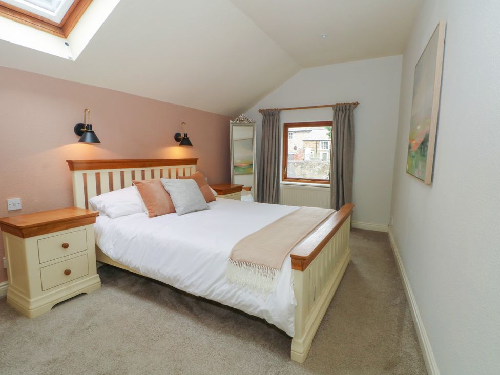 A bedroom with a bed and mirror at The Brew House in Bakewell
