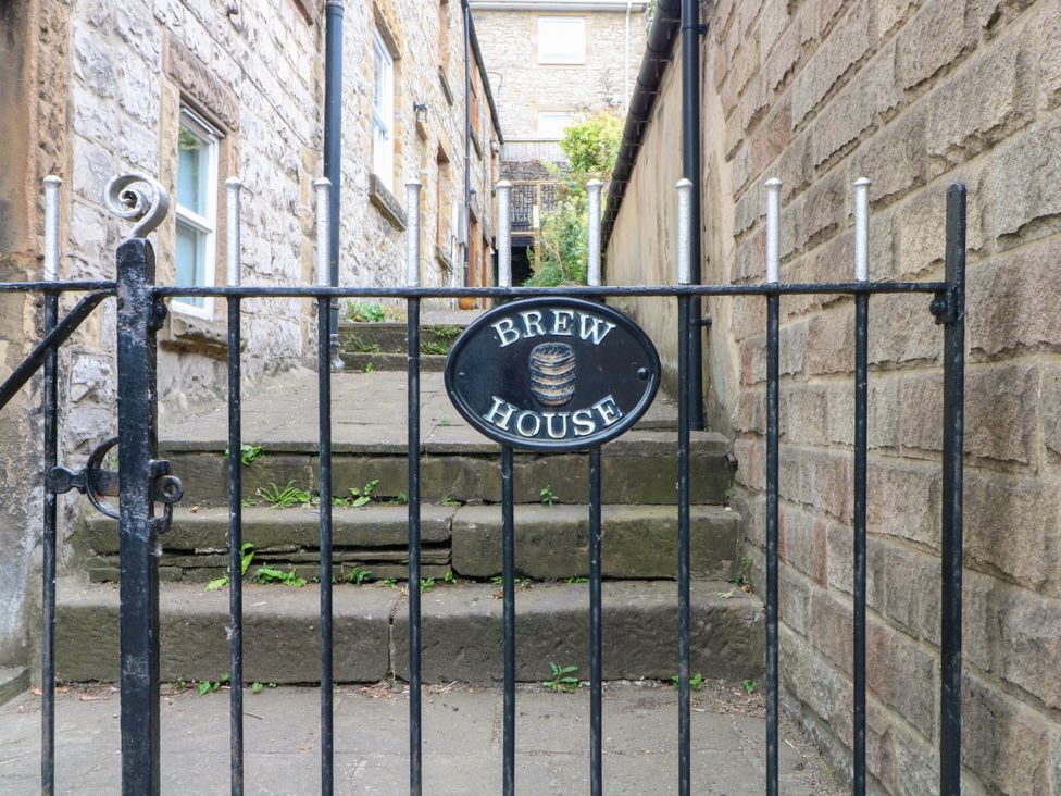 A gate with Brew House sign and stone steps at The Brew House in Bakewell