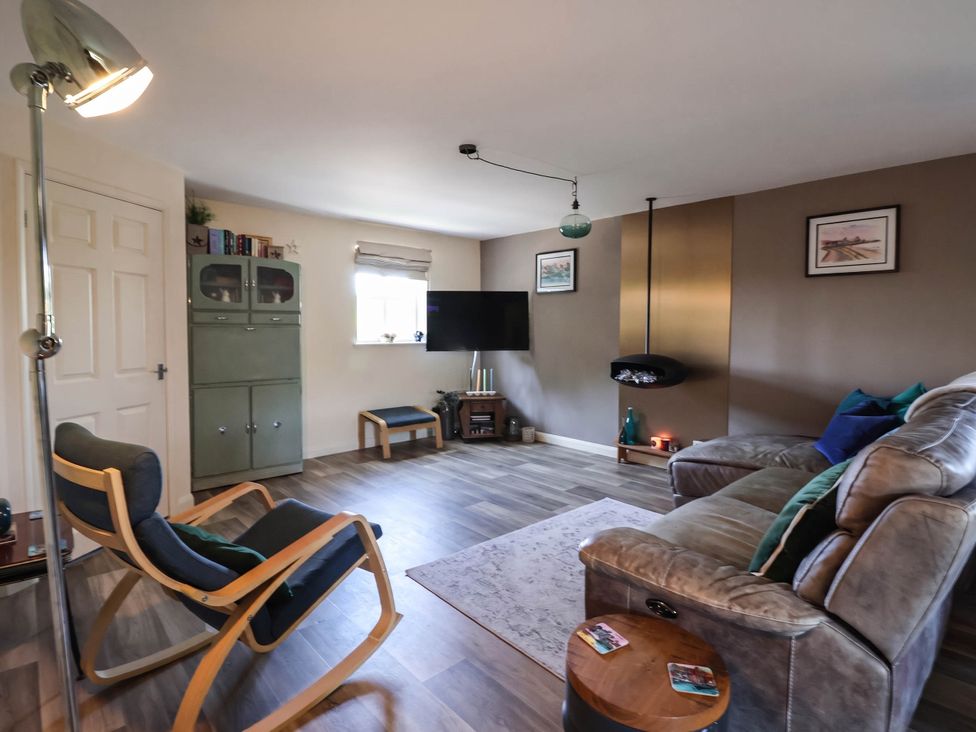 A living room with a sofa and television at 3 Mill Lane with HT in Grimsby