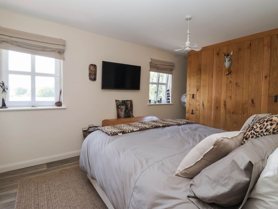 A bedroom with a bed and a television at 3 Mill Lane with HT in Grimsby