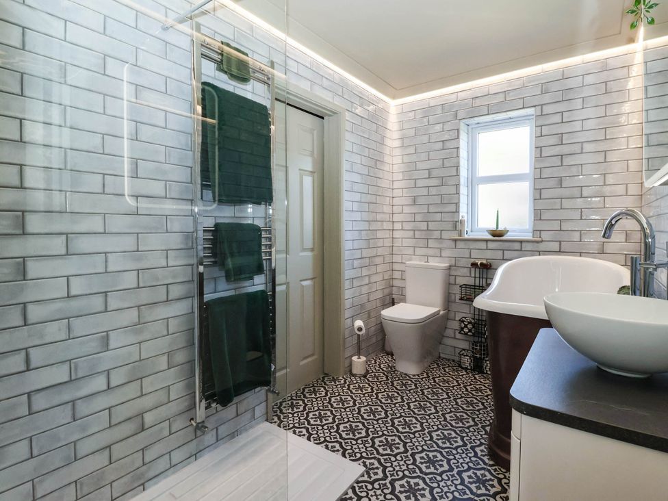 A bathroom with a shower sink and toilet at 3 Mill Lane with HT in Grimsby