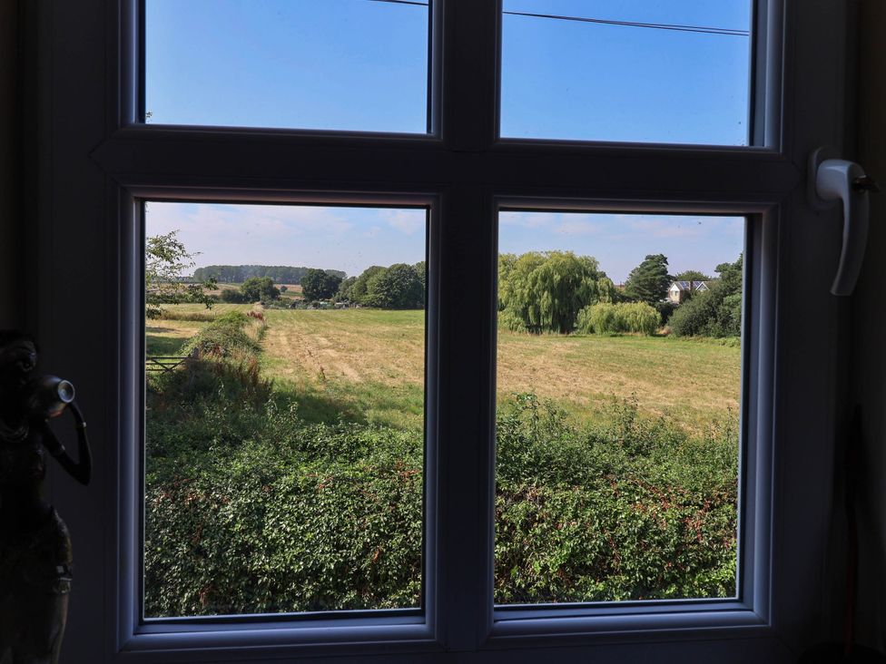 A view of a field and trees from a window at 3 Mill Lane with HT in Grimsby