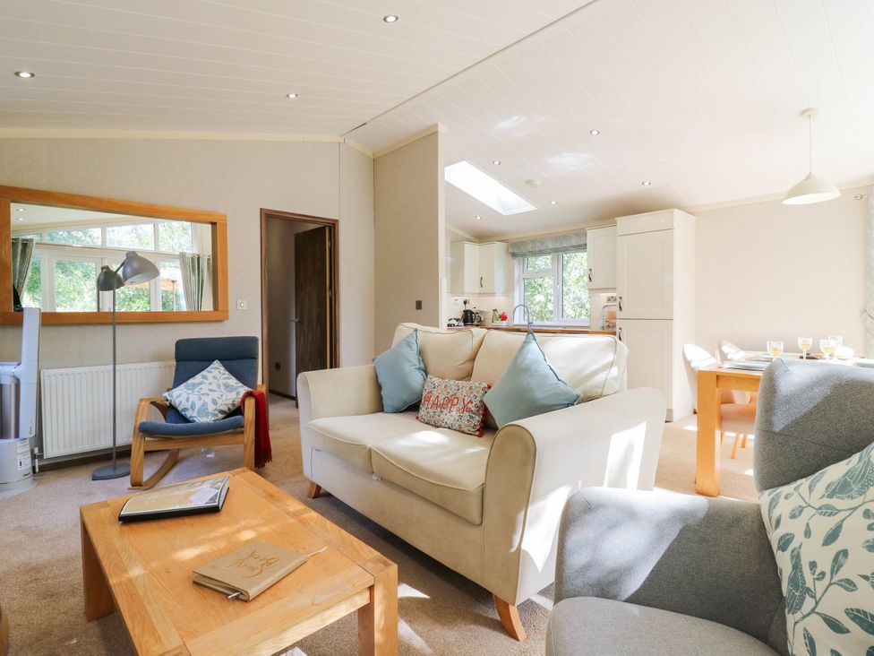 A living room with seating and dining area at Oak Lodge Battisford near Stowmarket