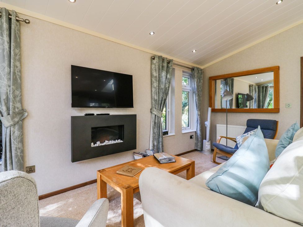 A living room with a television and fireplace at Oak Lodge Battisford near Stowmarket