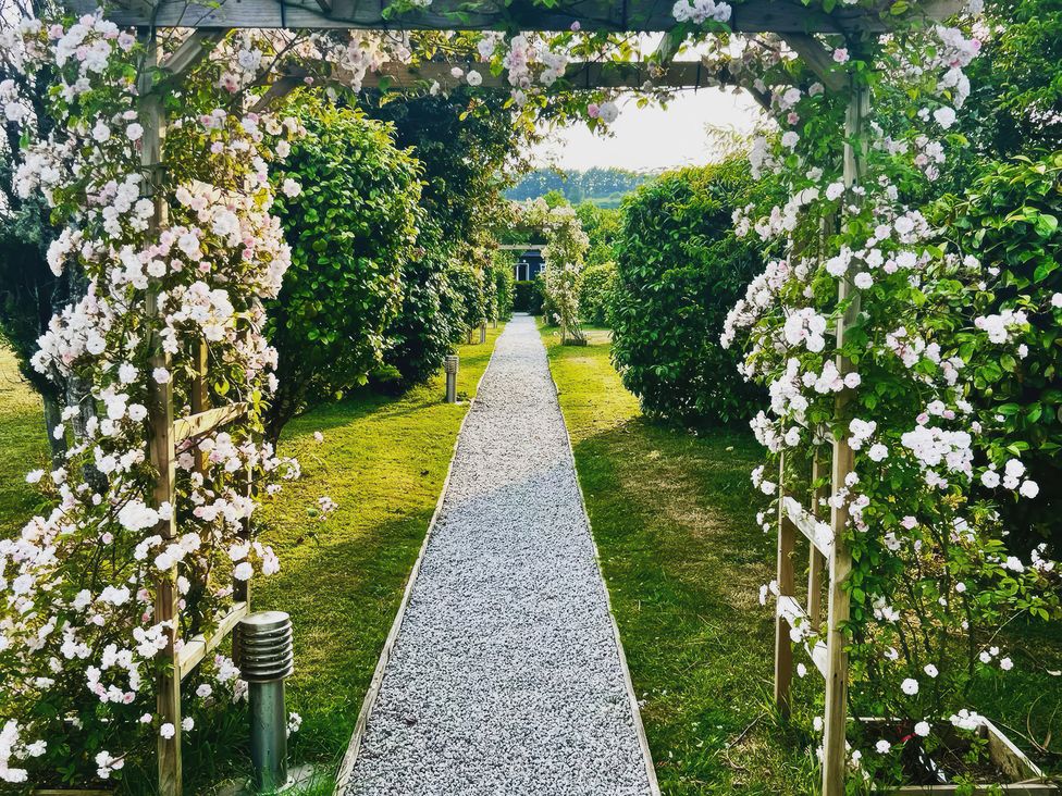 A garden path surrounded by flowers at Cuddle Cabin in Constantine