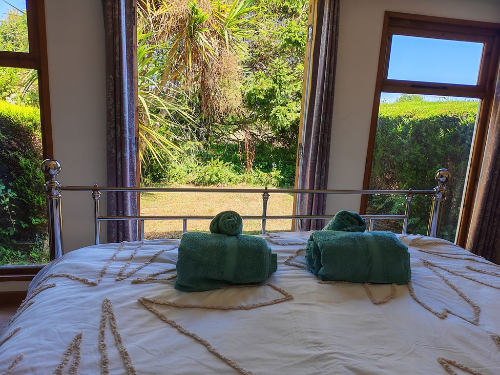 A bedroom with a bed and towels placed on it at Hazel Lodge in Constantine