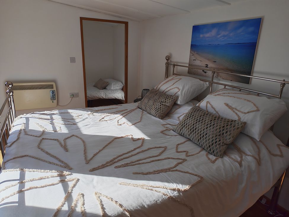 A bedroom with a bed and a picture on the wall at Hazel Lodge in Constantine