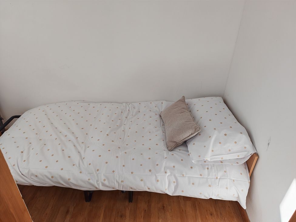 A bed with a pillow and blanket at Hazel Lodge in Constantine