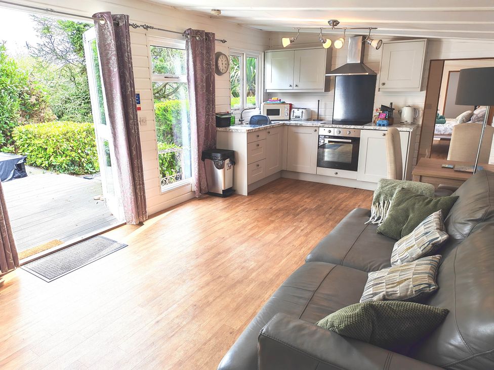 A living room with kitchen cabinets and a sofa at Hazel Lodge in Constantine
