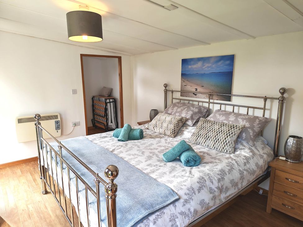 A bedroom with a bed and painting at Hazel Lodge in Constantine