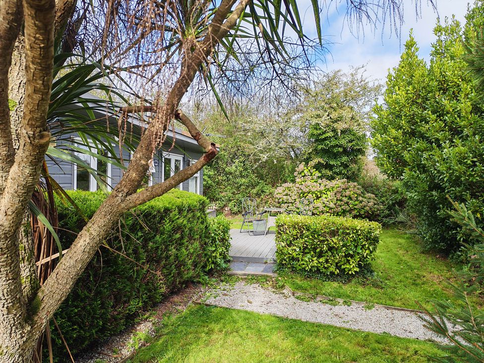 A garden with seating area and pathway at Hazel Lodge in Constantine