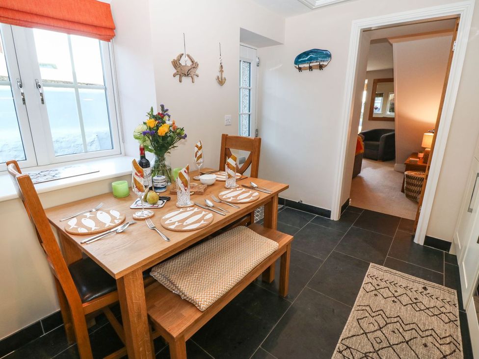 A dining room with a table set for a meal at Bryn Tirion - Rhosneigr