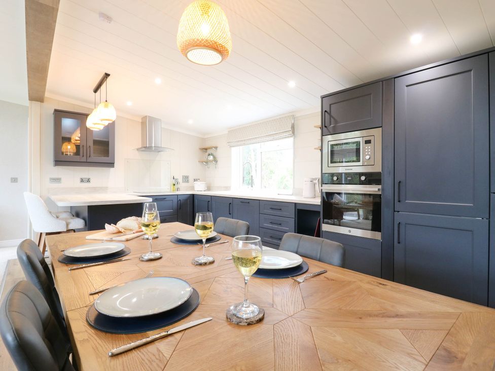 A kitchen with a dining table set at Cherry Lodge Battisford near Stowmarket