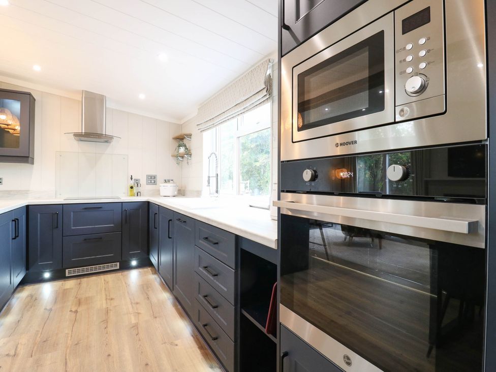 A kitchen with modern appliances and cabinets at Cherry Lodge Battisford near Stowmarket