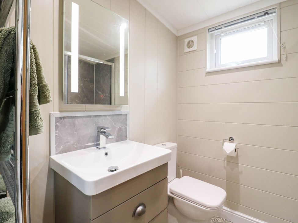 A bathroom with a sink and mirror at Cherry Lodge Battisford near Stowmarket