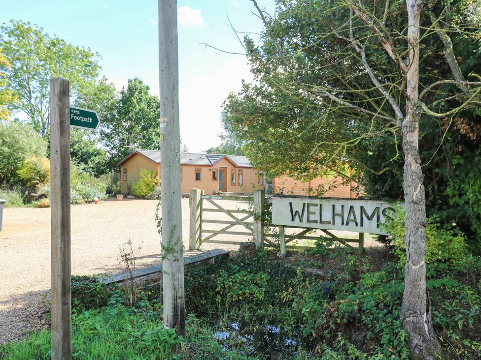 A sign and footpath indication near a building at Cherry Lodge in Battisford near Stowmarket