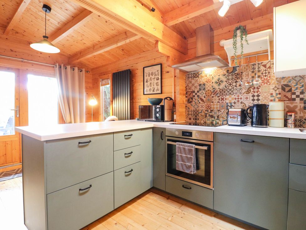 A kitchen featuring an oven and coffee maker at Willow Lodge Stowmarket